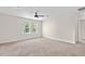Bright bedroom featuring a ceiling fan, neutral walls, and carpet with a view from the double window at 316 Beachgrass Ln, Summerville, SC 29486