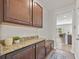 Butler's pantry features granite countertops, dark wood cabinets, and backyard views at 316 Beachgrass Ln, Summerville, SC 29486