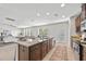 Open kitchen with granite countertops, stainless appliances and large island overlooking living area at 316 Beachgrass Ln, Summerville, SC 29486
