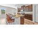 Modern kitchen with a large island, seating for four, granite countertops, and stainless steel appliances at 316 Beachgrass Ln, Summerville, SC 29486