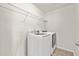Bright laundry room with modern white washer and dryer set and wire rack shelving at 316 Beachgrass Ln, Summerville, SC 29486