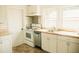Kitchen with white cabinets and stainless steel dishwasher, range and range hood at 317 Bay St, Walterboro, SC 29488