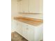 Bright pantry area with butcher block countertop and white cabinets at 317 Bay St, Walterboro, SC 29488
