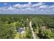 Aerial view of a home on lush land next to a dirt road bordered by dense forest at 326 Turner Ln, Round O, SC 29474