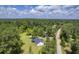 Aerial view of home with lush lawn and shed along a dirt road bordered by dense forest at 326 Turner Ln, Round O, SC 29474
