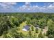 Aerial view of a home with a lush lawn surrounded by a dense forest and storage shed at 326 Turner Ln, Round O, SC 29474