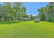 Spacious backyard with a well-maintained lawn, mature trees, and outbuilding at 326 Turner Ln, Round O, SC 29474