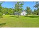 Wide shot of the home with a large backyard and detached garage at 326 Turner Ln, Round O, SC 29474