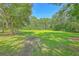 Shady backyard featuring mature trees and a sprawling green lawn at 326 Turner Ln, Round O, SC 29474