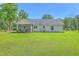 Large backyard with view of home, screened in porch, and detached garage at 326 Turner Ln, Round O, SC 29474