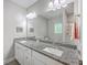 Bathroom features double sinks, granite countertop, and a large mirror over white cabinets at 326 Turner Ln, Round O, SC 29474