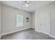 Bedroom with ceiling fan, light gray walls, and wood flooring at 326 Turner Ln, Round O, SC 29474