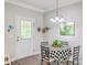Cozy dining area features a round table, patterned tablecloth, and access to an outdoor space at 326 Turner Ln, Round O, SC 29474