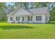 Charming single-story home with a welcoming front porch and manicured lawn at 326 Turner Ln, Round O, SC 29474