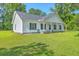 Charming white home with black shutters, a covered porch, and a lush green lawn at 326 Turner Ln, Round O, SC 29474