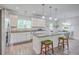Bright kitchen boasts granite counters, white cabinets, stainless appliances, and stylish island seating at 326 Turner Ln, Round O, SC 29474