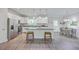 Spacious kitchen with island, white cabinets, and breakfast bar, seamlessly connecting to the dining area at 326 Turner Ln, Round O, SC 29474
