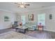 Bright living room with hardwood floors, comfortable seating, and abundant natural light from large windows at 326 Turner Ln, Round O, SC 29474