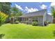 Expansive backyard featuring a screened in porch, mature landscaping, and plenty of green grass at 3312 Telford Ct, Summerville, SC 29485