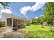 Sprawling backyard featuring a screened in porch, lush lawn, and mature landscaping at 3312 Telford Ct, Summerville, SC 29485