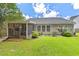 Picture perfect backyard with a screened in porch and mature landscaping and flowering plants at 3312 Telford Ct, Summerville, SC 29485