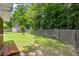 Level backyard featuring a storage shed, mature trees, and a wooden privacy fence at 3312 Telford Ct, Summerville, SC 29485