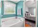 Bright bathroom with a soaking tub, window for natural light, and access to the main bedroom at 3312 Telford Ct, Summerville, SC 29485