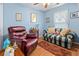 Cozy bedroom featuring a red recliner, sleeper sofa, hardwood flooring, and light blue walls at 3312 Telford Ct, Summerville, SC 29485
