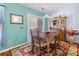 Dining area with a wooden table, decorative rug, and a view of the sliding glass door at 3312 Telford Ct, Summerville, SC 29485