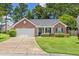 Charming brick home with a well-manicured lawn and an attached two-car garage at 3312 Telford Ct, Summerville, SC 29485