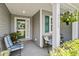 Inviting front porch with seating, decorative plants, and stylish front door with wreath at 3312 Telford Ct, Summerville, SC 29485