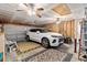 Finished garage featuring a white SUV, an epoxy floor, peg board, and a ceiling fan at 3312 Telford Ct, Summerville, SC 29485
