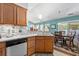 Beautiful kitchen with stainless steel dishwasher and granite countertops, flowing into a dining area and a view of the backyard at 3312 Telford Ct, Summerville, SC 29485