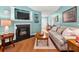 Living room with a cozy fireplace, hardwood floors, and a view of the entryway at 3312 Telford Ct, Summerville, SC 29485