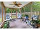 Screened porch with a ceiling fan, outdoor chairs, greenery, and lattice panels at 3312 Telford Ct, Summerville, SC 29485