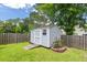 Backyard shed with easy ramp access, surrounded by mature landscaping and wooden fence at 3312 Telford Ct, Summerville, SC 29485