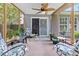 Relaxing screened sunroom with ceiling fan, sliding glass door, and lovely seating arrangements at 3312 Telford Ct, Summerville, SC 29485
