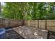 Wooden backyard deck with wood privacy fence, surrounded by mature trees offering shade for outdoor relaxation at 4028 Babbitt St, Charleston, SC 29414