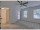This is a bedroom with neutral-toned walls, carpet, windows and an exit to the outside at 4028 Babbitt St, Charleston, SC 29414