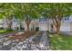 Charming townhome exterior featuring a one car garage, complimented by mature landscaping in a neighborhood at 4028 Babbitt St, Charleston, SC 29414
