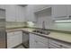 Modern kitchen with stainless steel appliances, white cabinets, and neutral countertops at 4028 Babbitt St, Charleston, SC 29414
