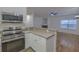 Kitchen area with stainless steel appliances, white cabinets, and an open view to the living area at 4028 Babbitt St, Charleston, SC 29414