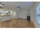 Inviting living room featuring hardwood floors, a fireplace, and an open-concept design with a kitchen view at 4028 Babbitt St, Charleston, SC 29414