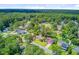 An aerial view showcasing the neighborhood and the surrounding lush greenery and mature trees at 405 Amberjack Way, Summerville, SC 29485