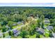 Aerial view of the community showcasing many homes surrounded by mature trees and green spaces at 405 Amberjack Way, Summerville, SC 29485