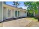 A cozy backyard featuring a concrete patio and a well-maintained, light-grey home exterior at 405 Amberjack Way, Summerville, SC 29485