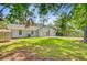 Spacious backyard with a well-maintained lawn and mature trees offering ample shade at 405 Amberjack Way, Summerville, SC 29485