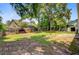Spacious backyard with a lush lawn, surrounded by mature trees and a wood fence at 405 Amberjack Way, Summerville, SC 29485