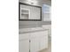 The bathroom features a large mirror, white vanity, and a window for natural light at 405 Amberjack Way, Summerville, SC 29485