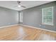 A light-filled bedroom with hardwood floors and multiple windows for great natural light at 405 Amberjack Way, Summerville, SC 29485